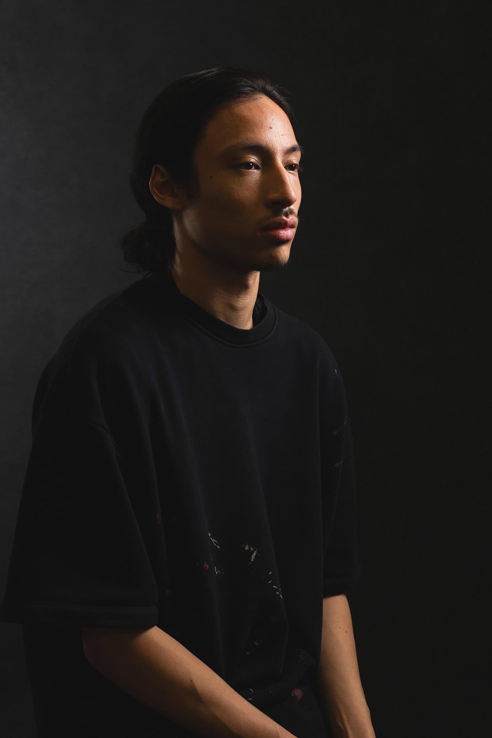 low key portrait of young male with long hair