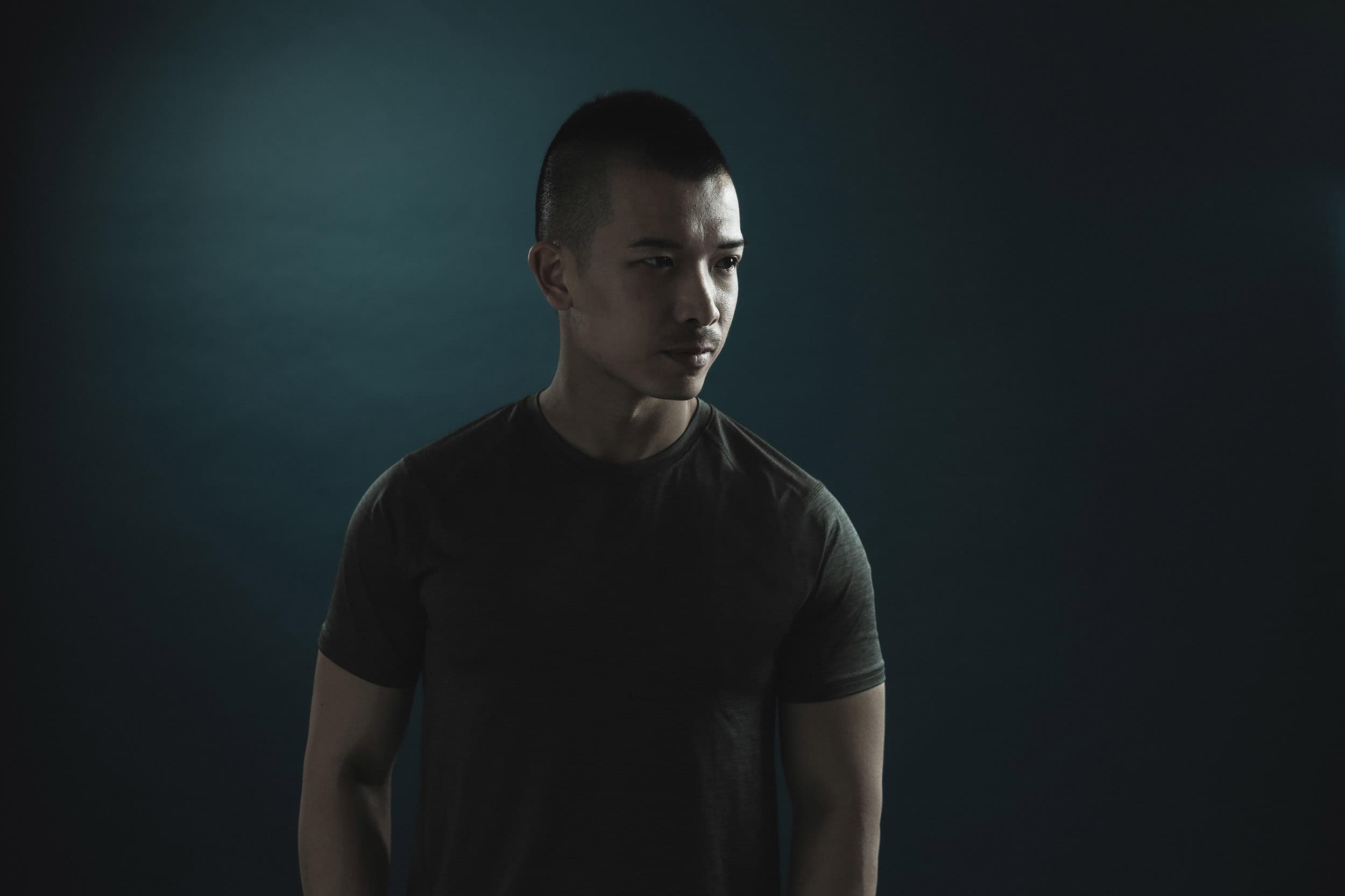 low key studio portrait of young asian male