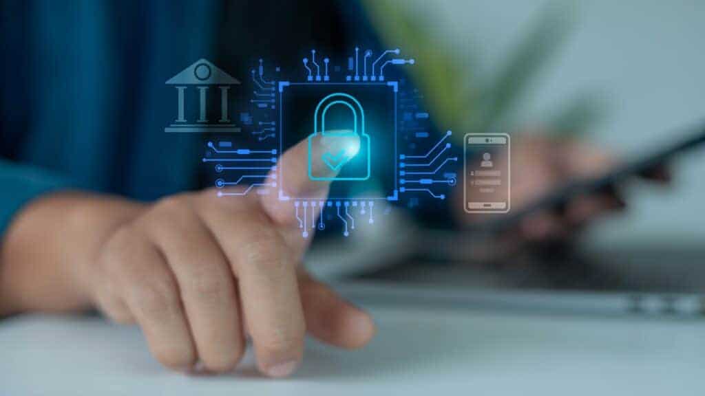 Pessoa toca uma interface digital com ícone de cadeado, enquanto símbolos de banco e celular representam autenticação e segurança digital.
