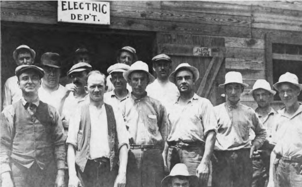 Black and white photo of group of people in Electric department