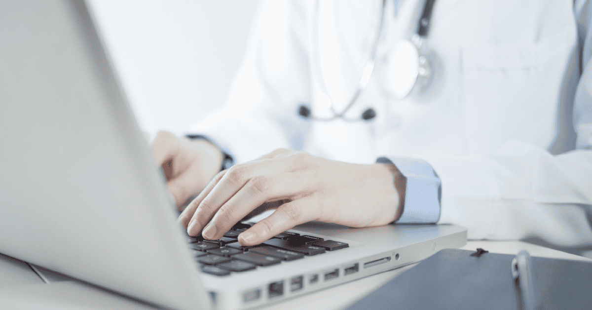 Clinician on a computer dealing with complex EHR workflows