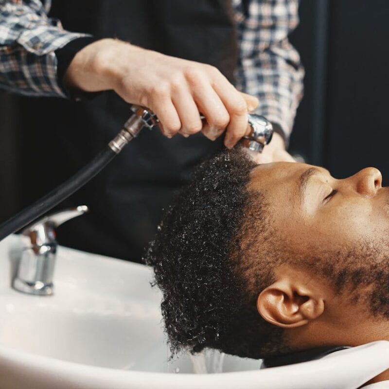 man washing hair with hard water