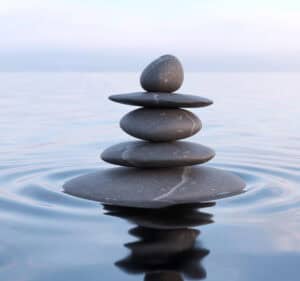 Balanced stones on calm water