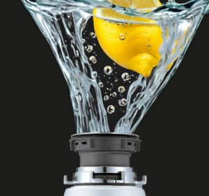 Lemon dipped in water with sparkling splashes.