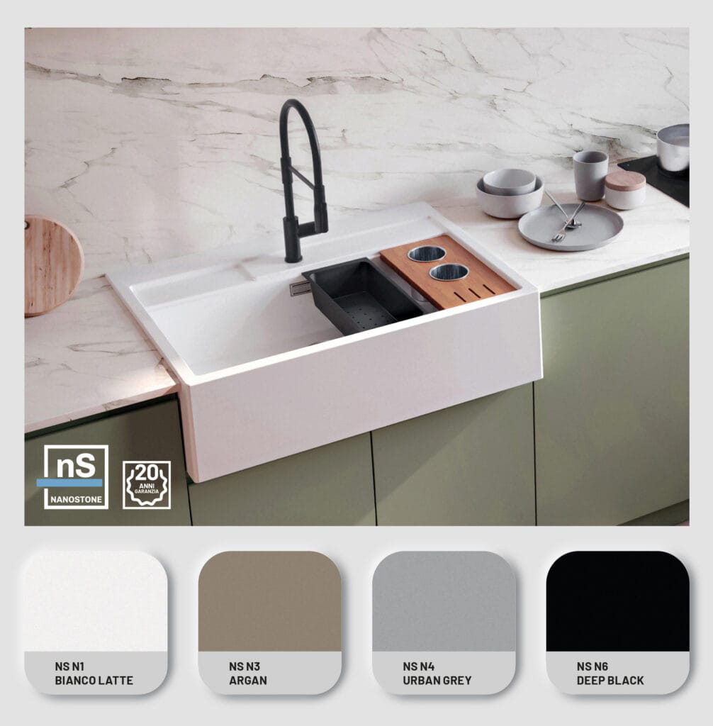 White kitchen sink with accessories on marble top.