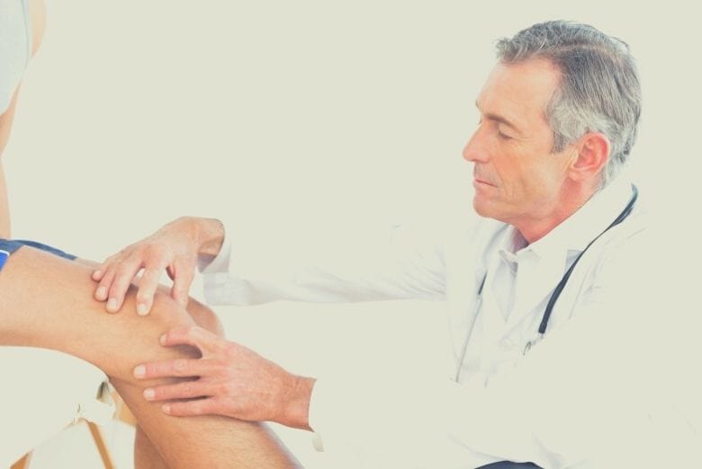 Man seeing a doctor for his knee joint pain