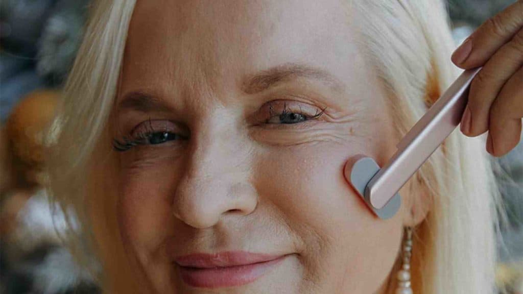 Woman using a SolaWave Wand on her face