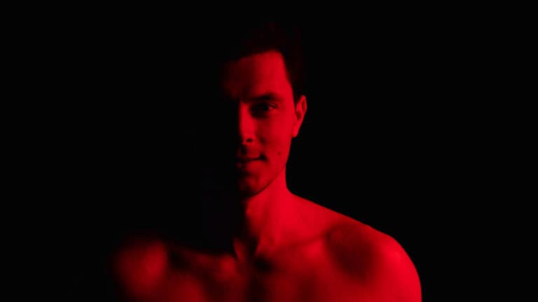 Man using a Joovv Solo red light therapy device