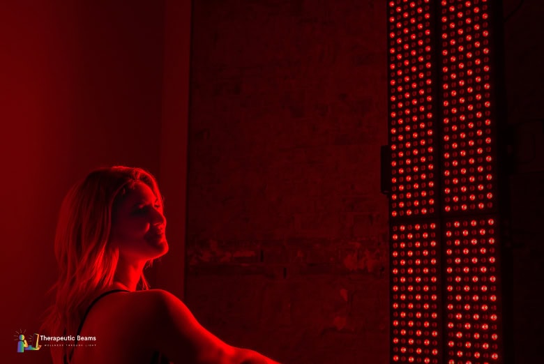 Woman using Mito Red Light panels while sitting down
