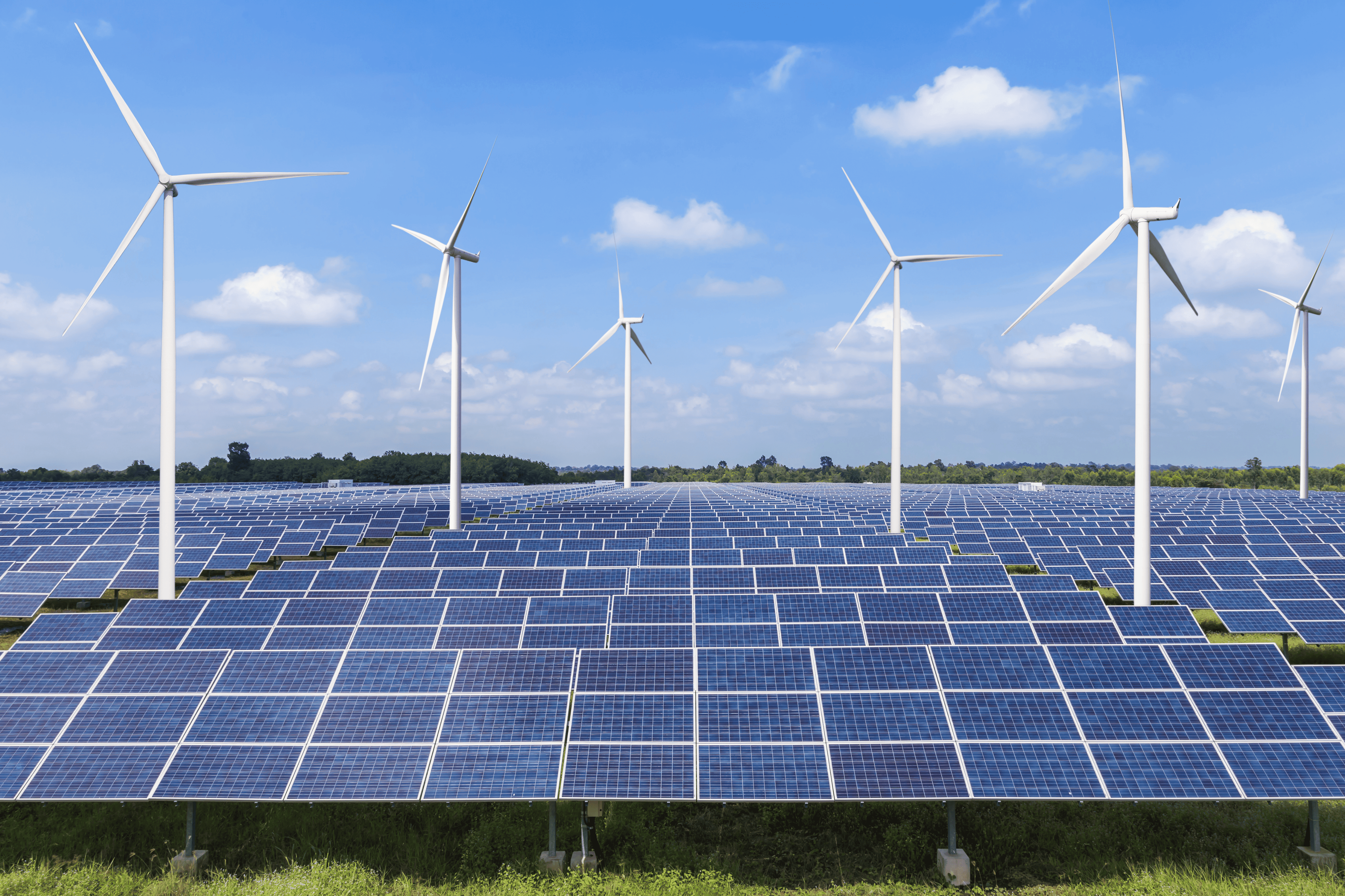 Renewable energy farm featuring solar panels and wind turbines representing sustainable energy generation, carbon offset initiatives, and the role of environmental credits in promoting clean power.