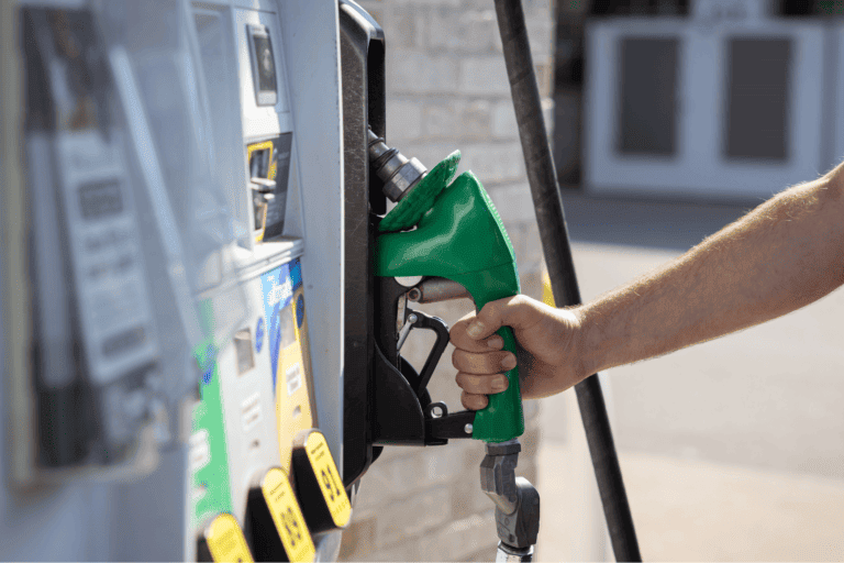 Fueling a vehicle at a gas station with U.S. energy and fuel efficiency focus.