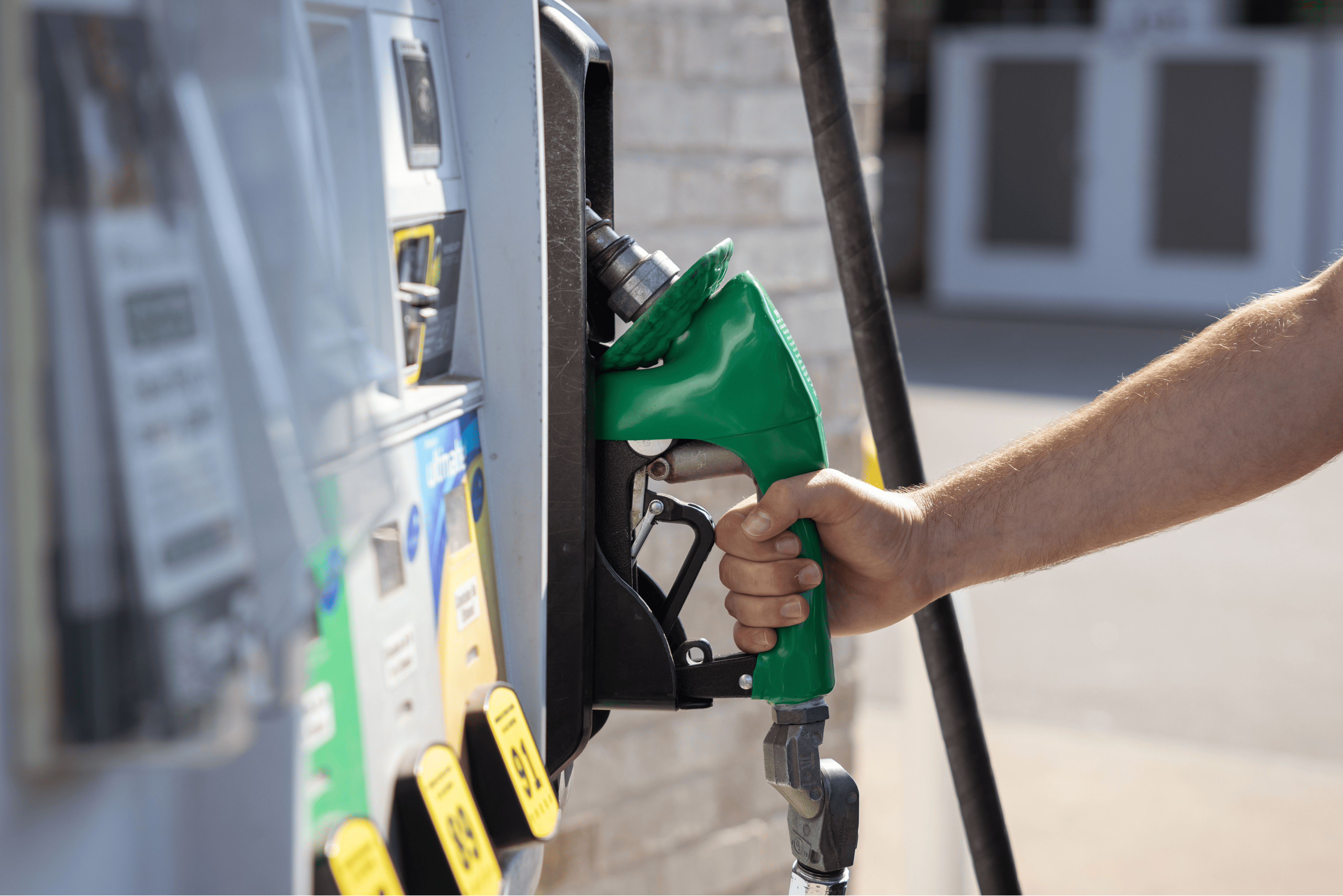Fueling a vehicle at a gas station with U.S. energy and fuel efficiency focus.