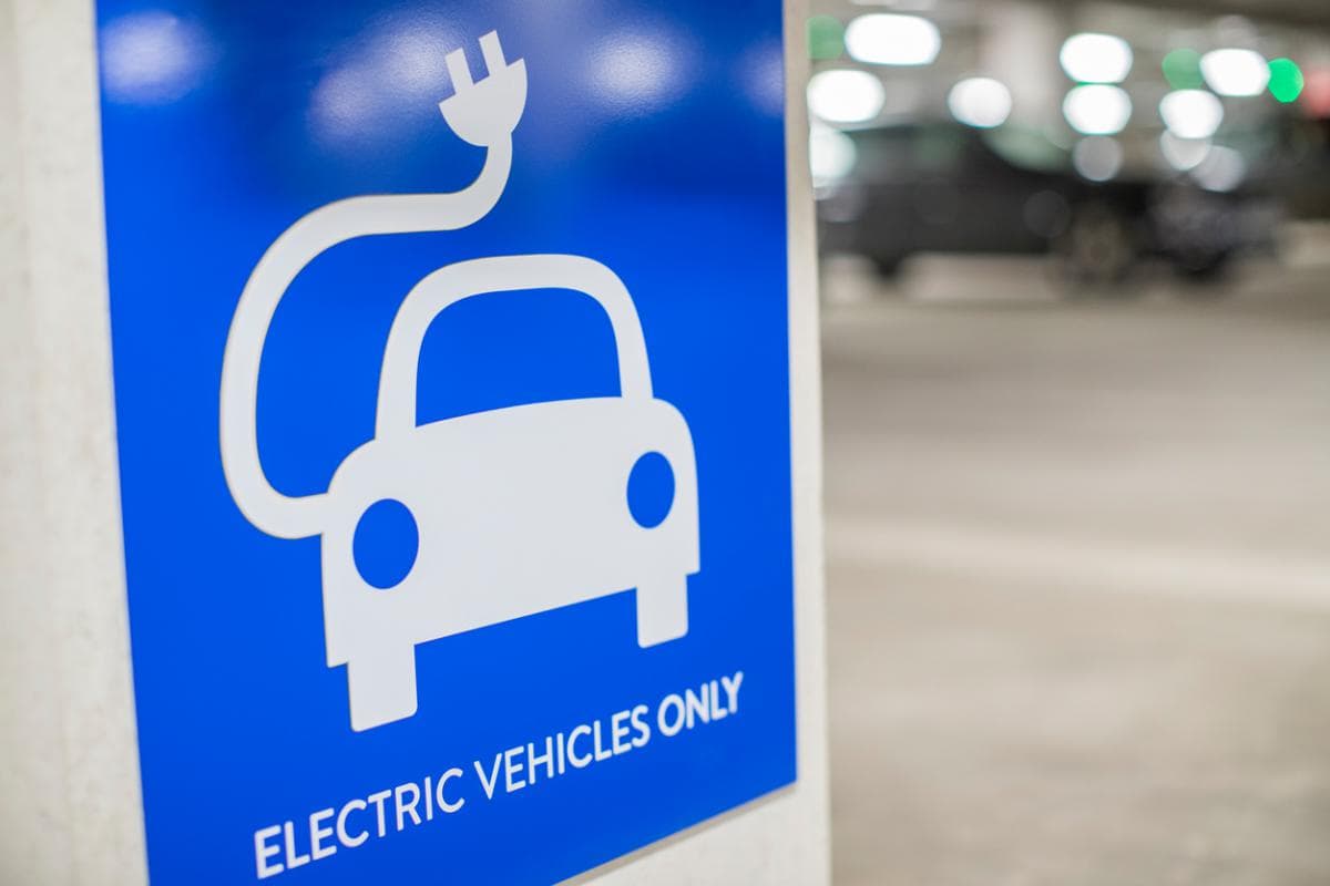 Electric vehicle charging station sign promoting clean energy and sustainable transportation.