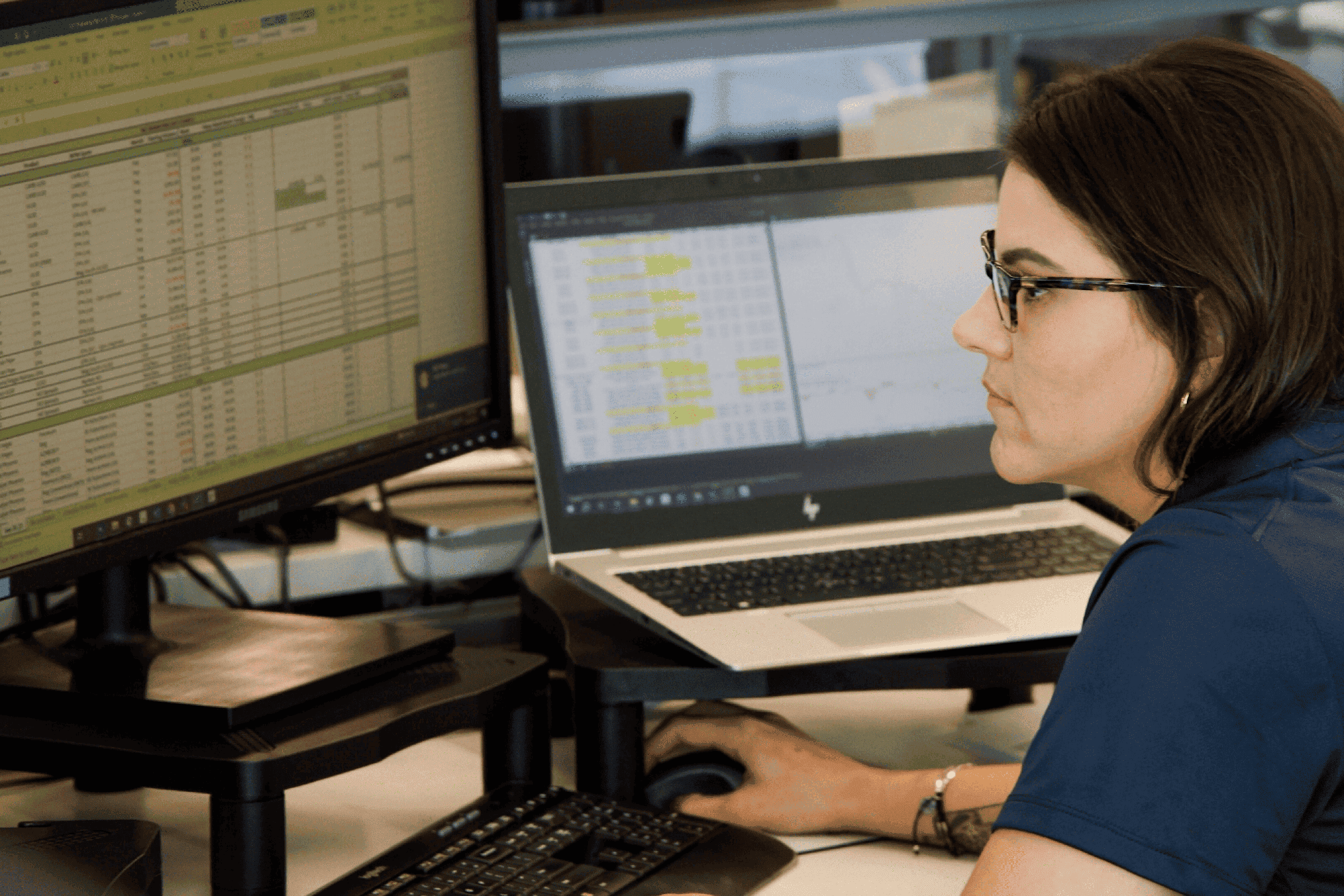 U.S. Energy employee working at desk. Computer monitor shown.