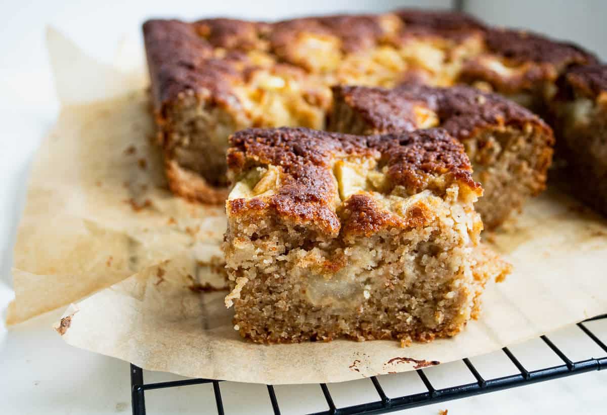 ginger apple cake on baking paper and a cooling rack