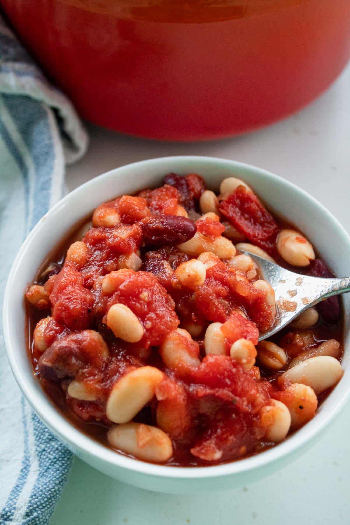 healthy homemade baked beans in a bowl with a spoon