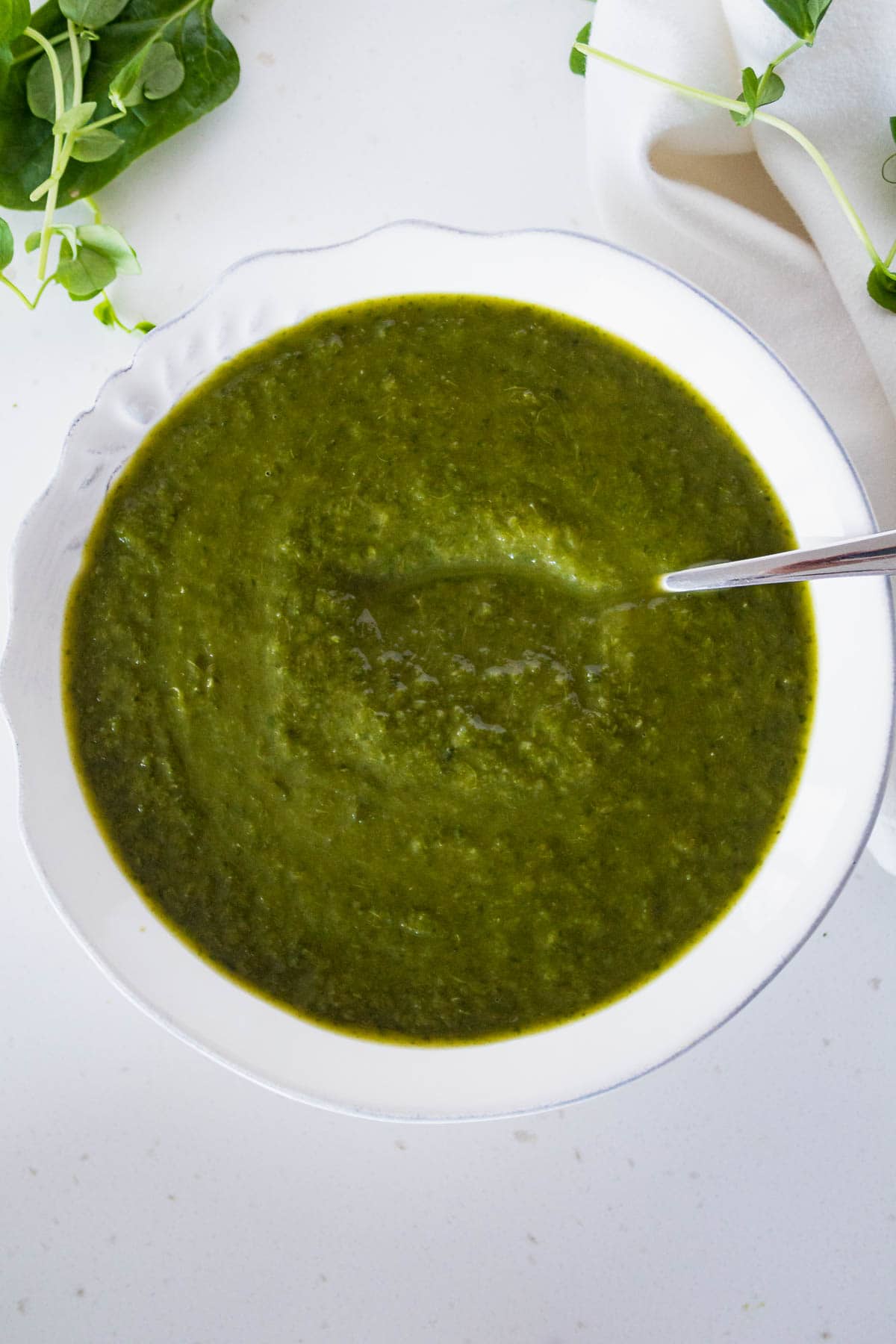 bowl of watercress soup with a spoon in it