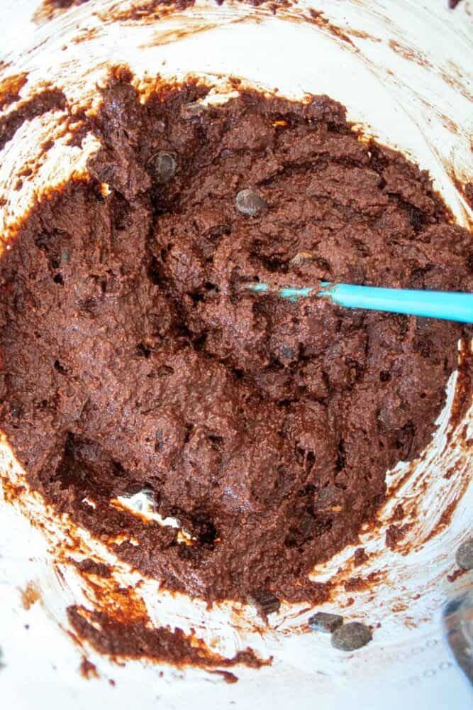 almond flour chocolate brownies batter in a bowl witha spatula.