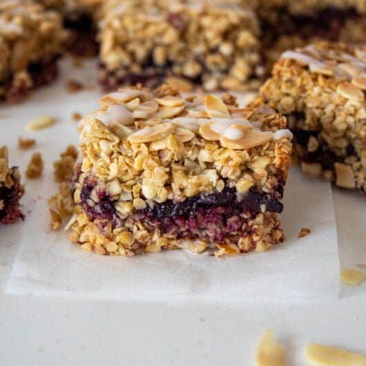 closeup of a bakewell flapjack with a cherry jam layer