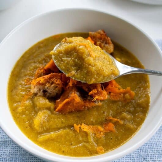 closeup of broccoli and butternut squash soup on a spoon