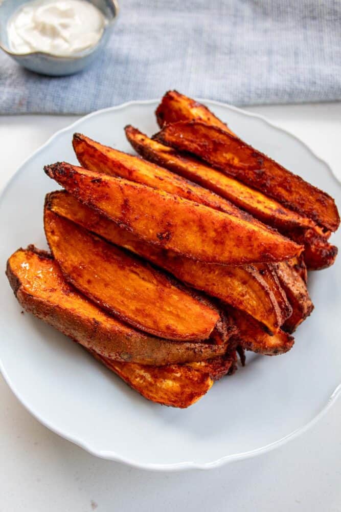 smoked paprika sweet potato wedges stacked on a plate