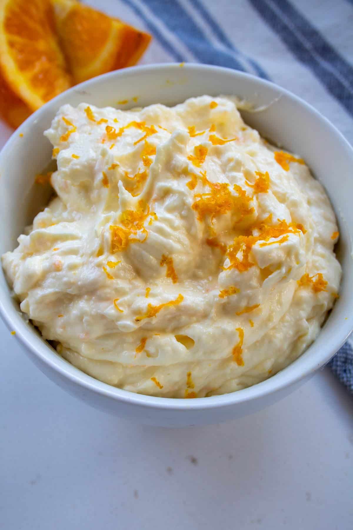 diabetic cream cheese frosting in a bowl with orange zest