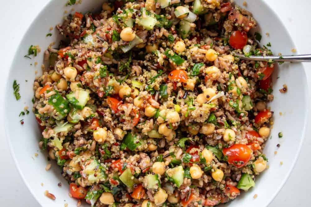 brown rice salad with chickpeas in a bowl with a spoon