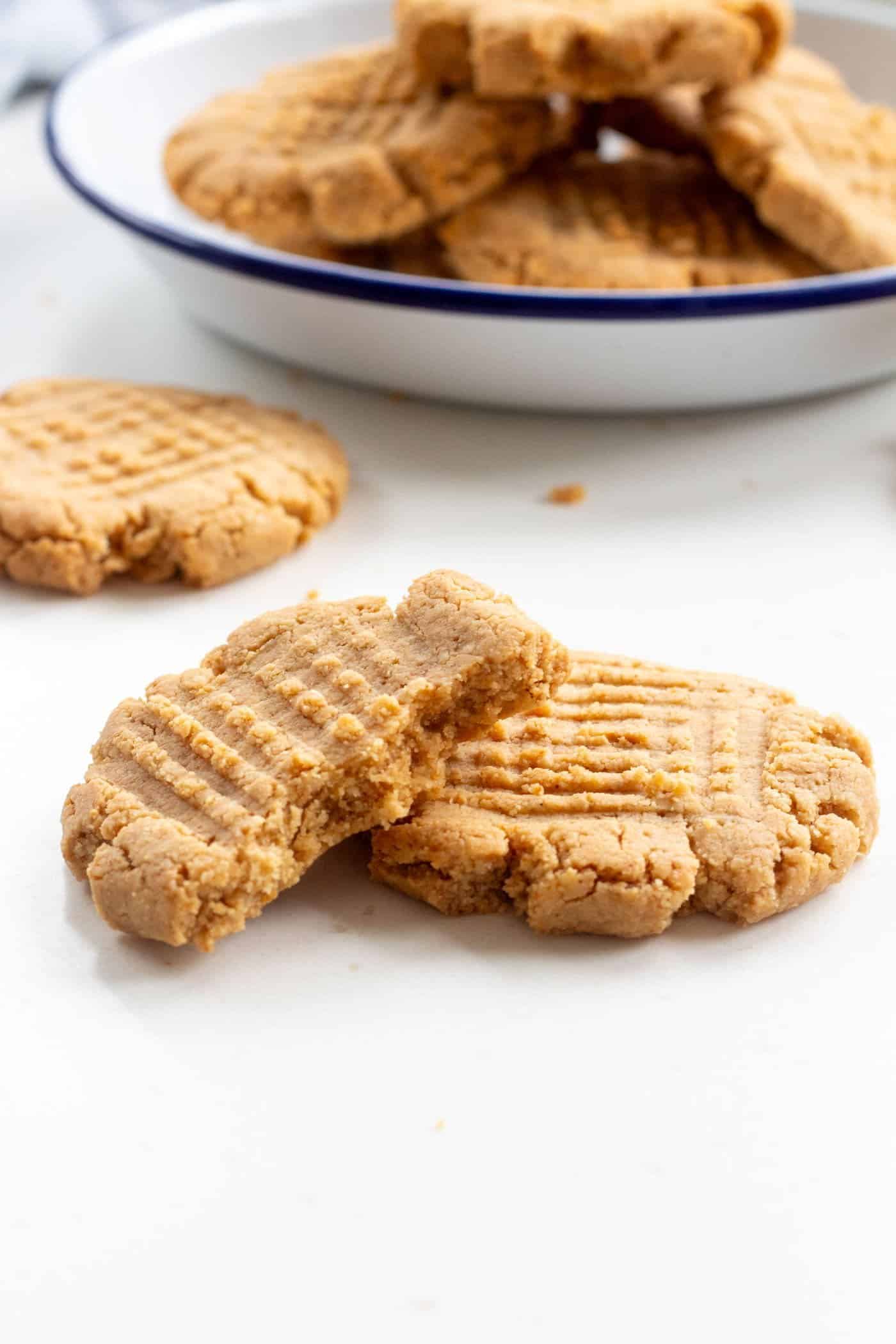 half a peanut butter cookie stacked onto another cookie