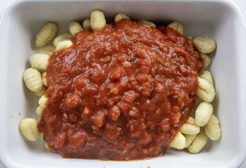gnocchi and tomato sauce in a ceramic baking dish unmixed