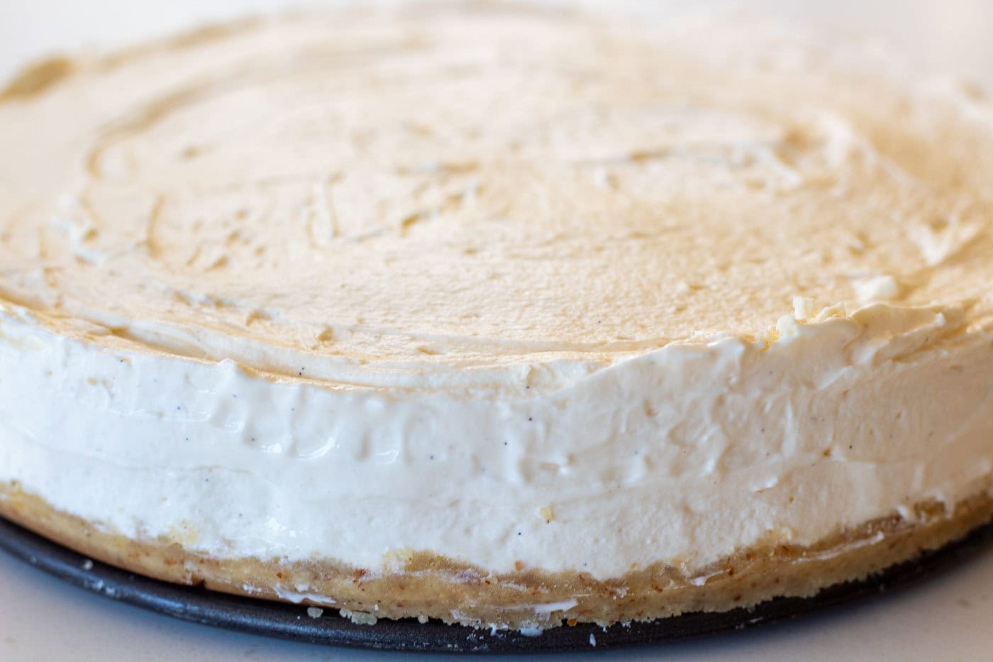 the whole low carb vanilla marscapone cheesecake on the cake tin base with its buttery almond base and soft creamy filling
