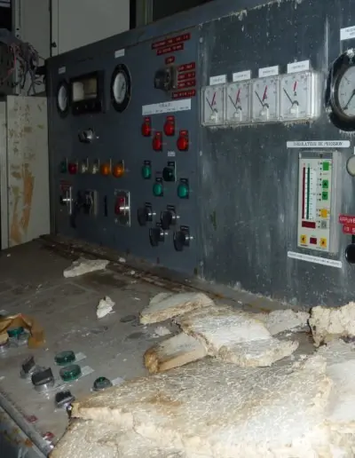 Control panel with various buttons, dials, and gauges showing signs of wear and age.