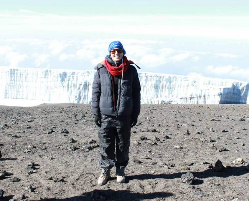 Kristen standing on the summit of Mt Kilimanajro