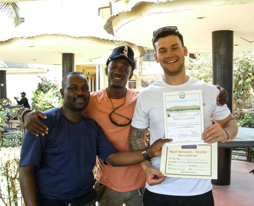 Luke receiving his summit certificate after climbing Mount Kilimanjaro