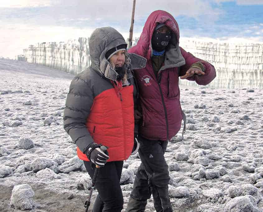 Yesse leading one of our clients to the summit of Mt Kilimanajro