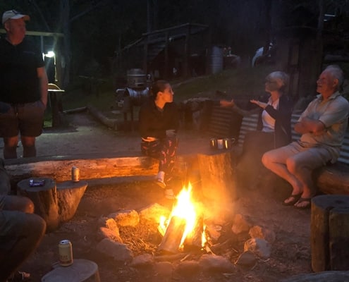 Sitting around the fire on the Six Foot Track eco lodge