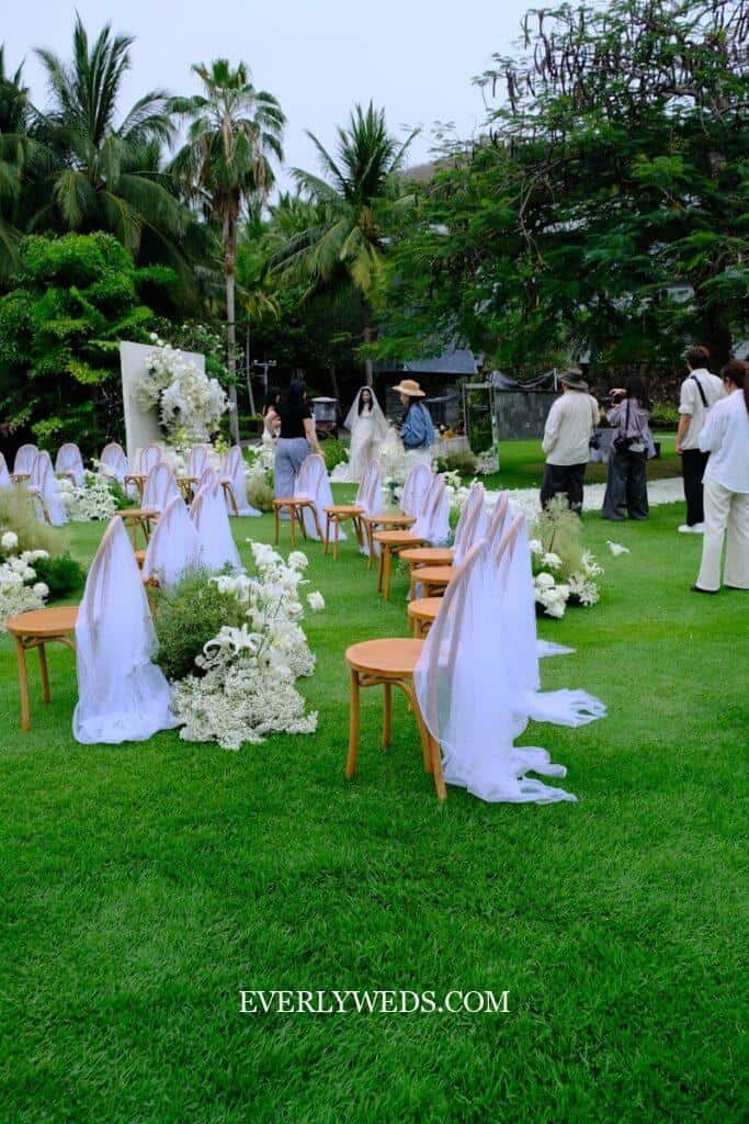 Outdoor wedding ceremony is being set up.