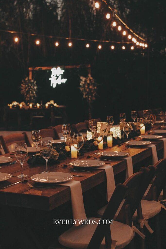 a long table is set with candles and place settings