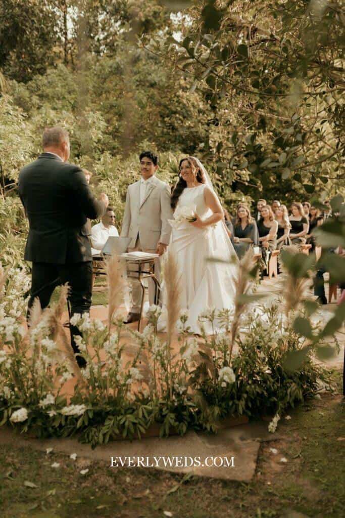 A bride and groom at an outdoor wedding ceremony.