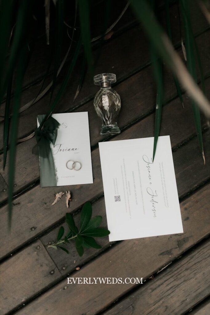 Wedding invitation details and a decorative perfume bottle.