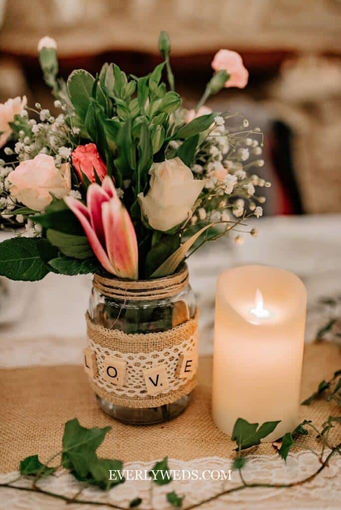 DIY rustic wedding centerpiece with mason jar, burlap, lace, flowers and candle - budget wedding decoration idea