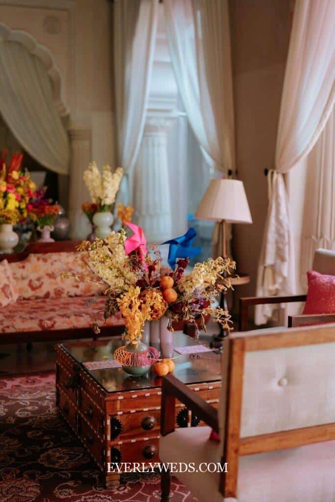 Budget wedding centerpiece with dried flowers and colorful ribbons on vintage glass table for small wedding decor