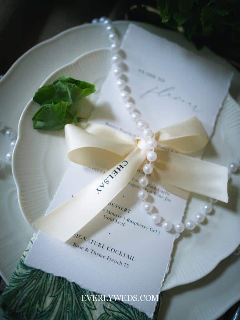 Elegant wedding menu with pearl bracelet and ribbon - creative save the date ideas for couples