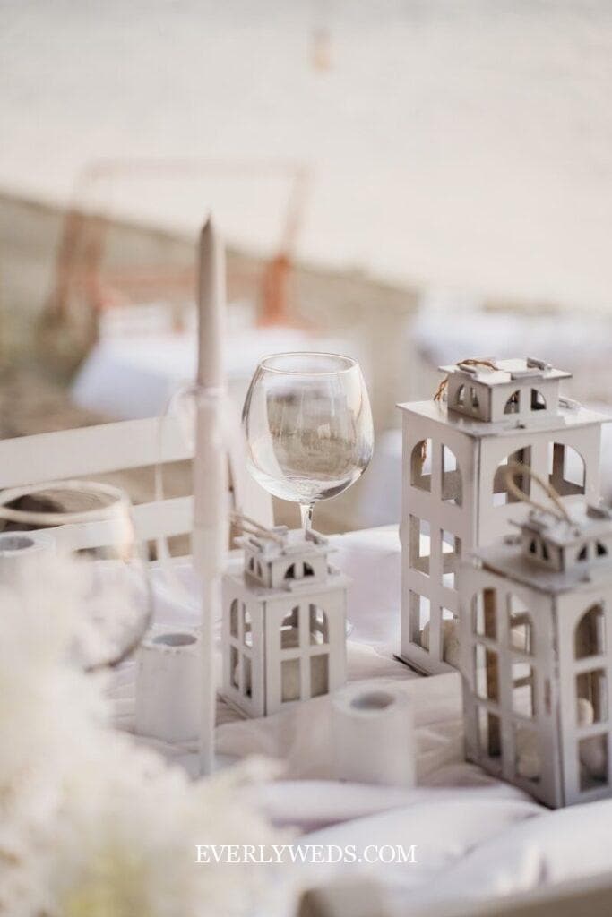 Creative wedding gift ideas including elegant white lantern centerpieces and wine glasses for couples on any budget