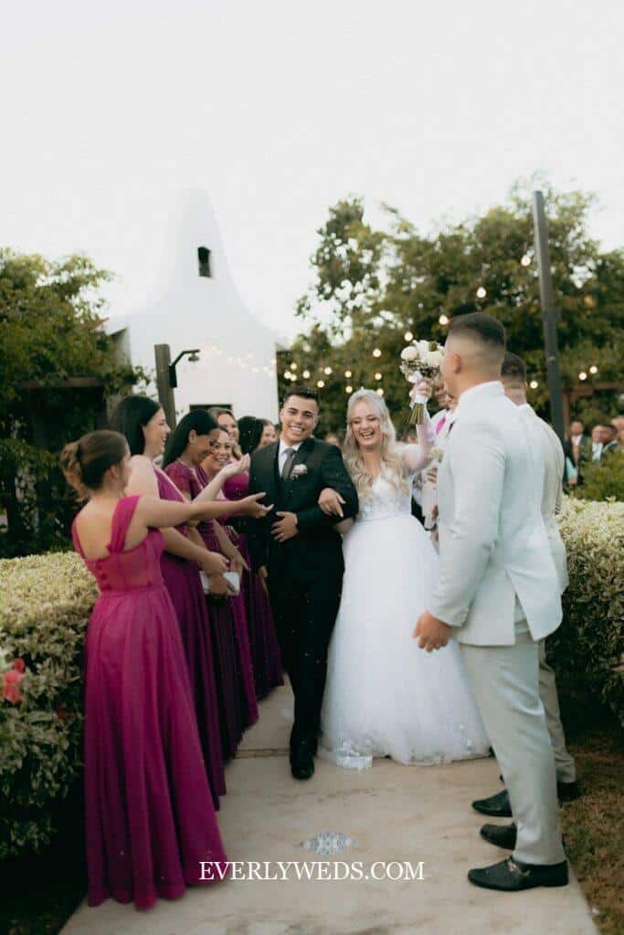 Bride and groom celebrating with wedding party in purple dresses - save the date ideas inspiration