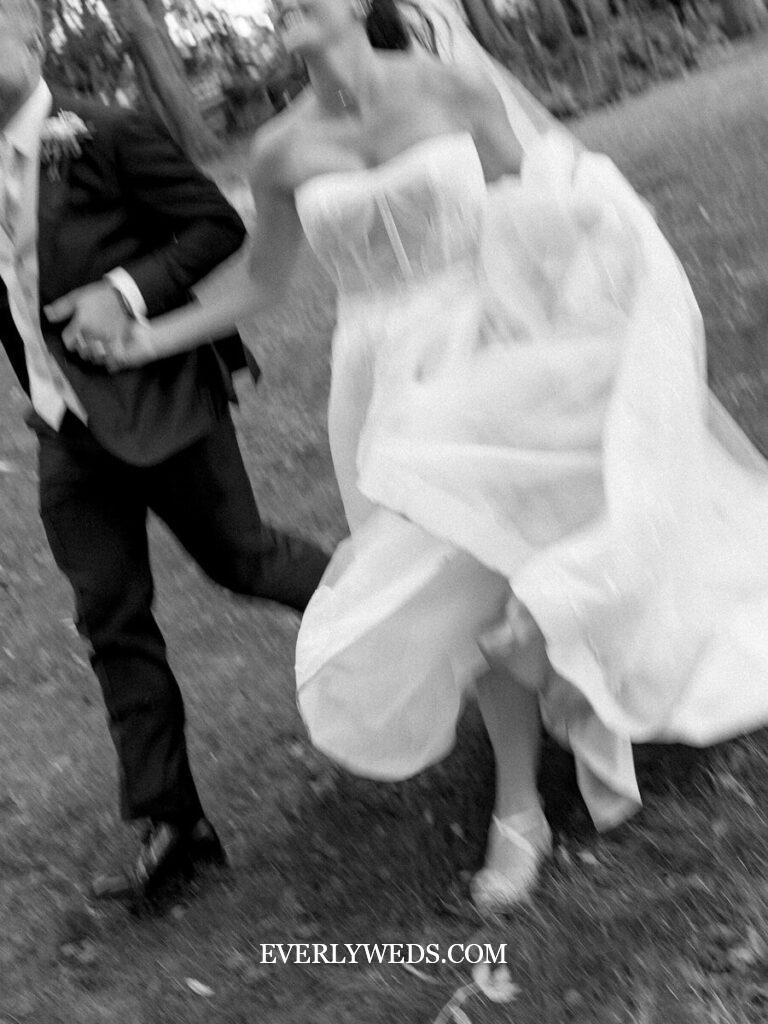 Bride and groom walking back down aisle to upbeat fun recessional wedding songs with guests cheering