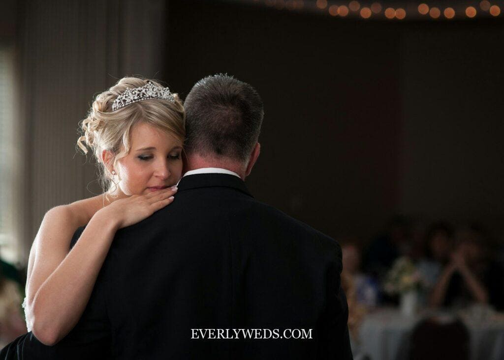 Stepdad dancing with bride at wedding reception emotional father figure dance
