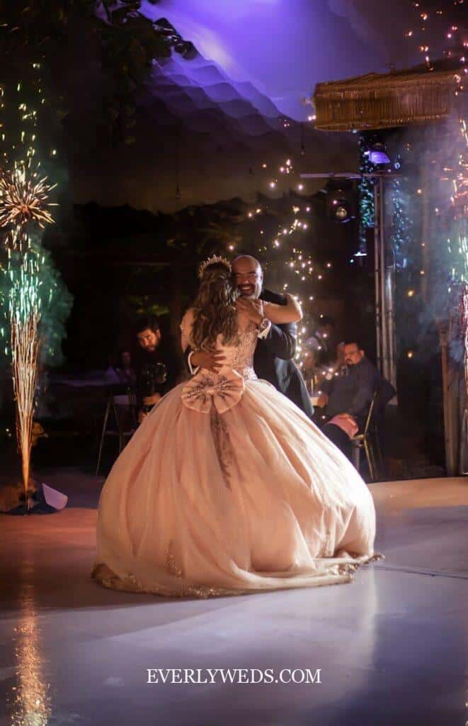 Romantic couple dancing at wedding reception with sparklers and elegant ballgown save the date ideas