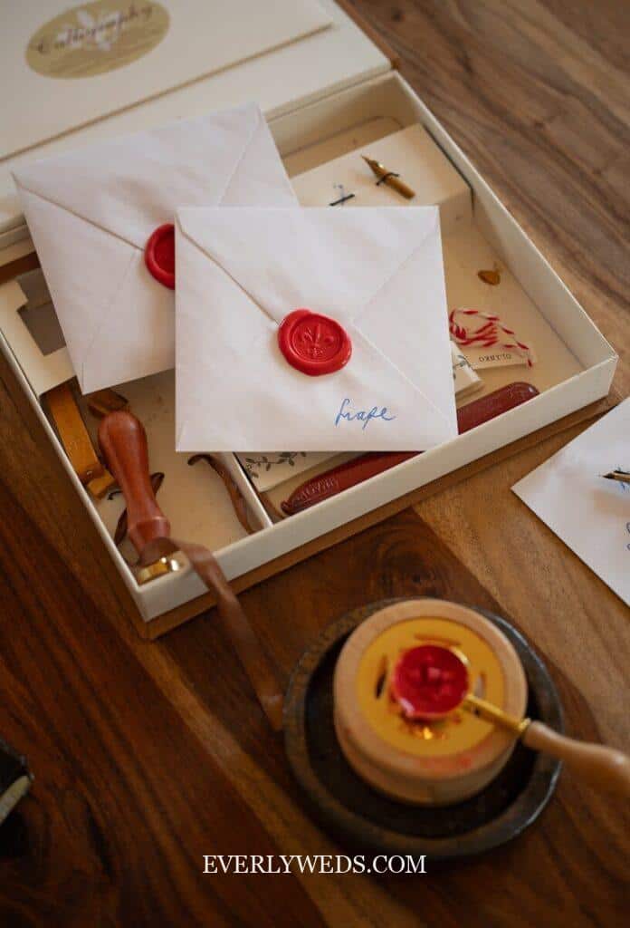 when to send wedding invites timeline flat lay with save the date and formal invitation cards