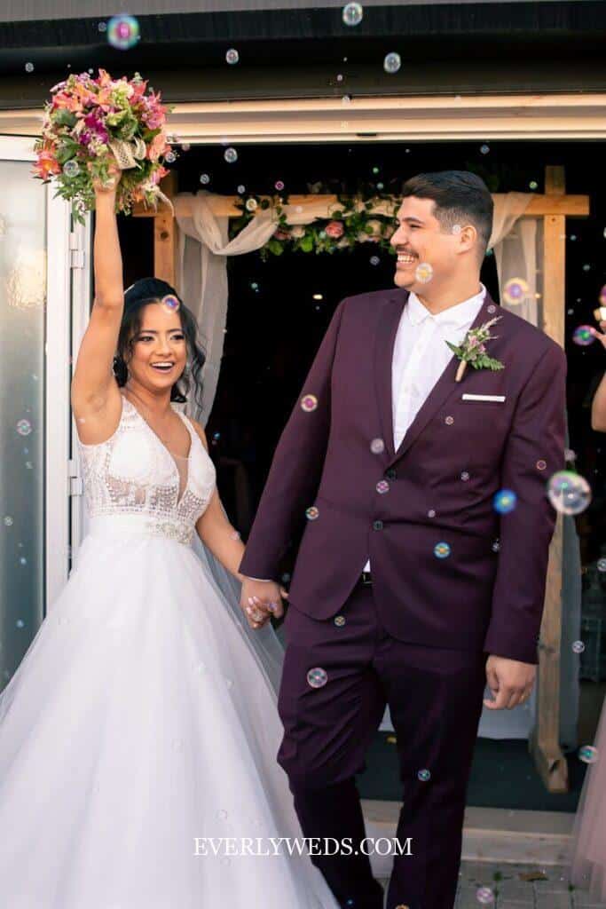 Newlywed couple celebrates with bubbles after ceremony - creative save the date ideas inspiration