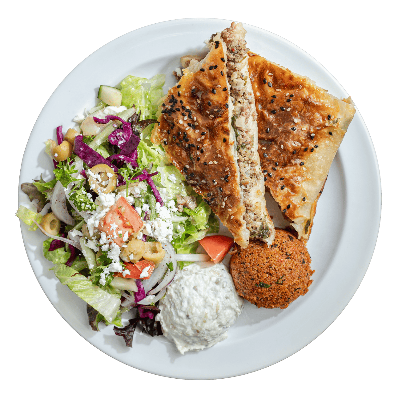 A plate with baked pastry topped with seeds, green salad with olives and feta, a dollop of white dip, and a serving of red-brown falafel.